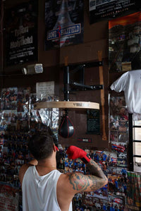 variant:lifestyle::TITLE Boxing Gyro Balanced Leather Speed Bag guy hitting xxs