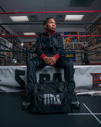variant:lifestyle::black sports equipment bag next to boxing ring
