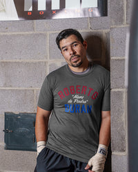 variant:grey::TITLE Boxing Legacy Roberto Duran "Mano De Piedra"Tee guy posing against the wall