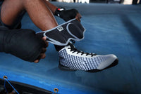 variant:lifestyle::TITLE Boxing Pro Ankle Weights putting on ankle