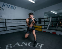 variant:black/black::TITLE Boxing Professional Traditional Cut Trunks guy in ring boxing pose
