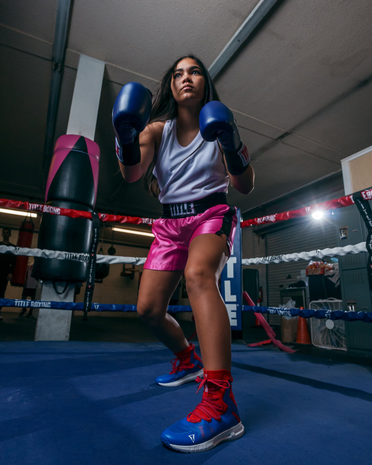 variant:pink/black::TITLE Boxing Professional Women’s Satin Striped Boxing Trunks girl in ring boxing pose