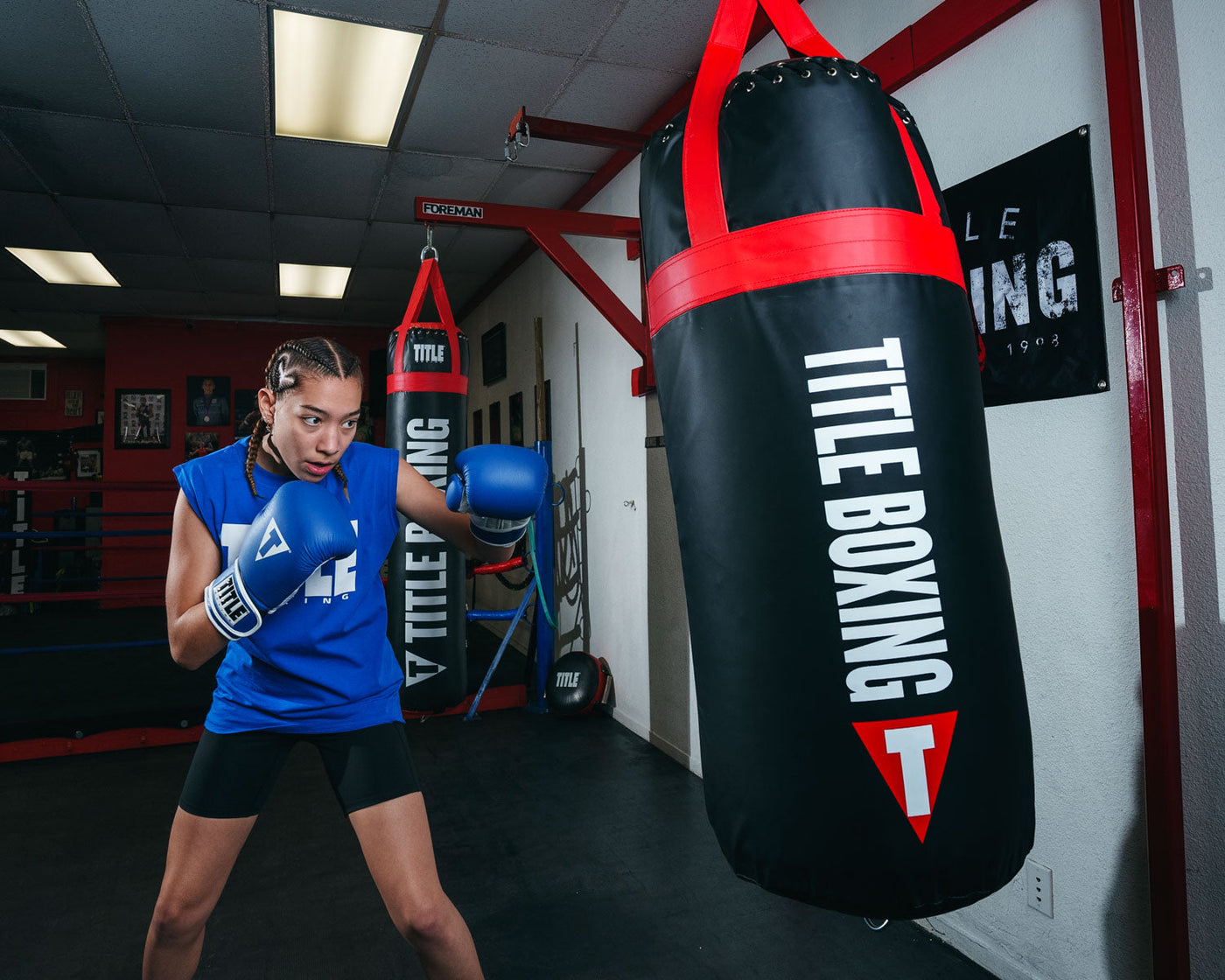 variant:Blue/White::TITLE Boxing Pro Style Leather Training Gloves 3.0 girl hitting bag