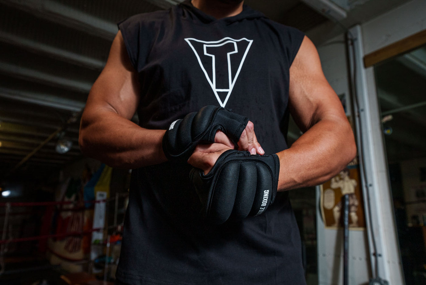 variant:black::TITLE Boxing Weighted Gloves 2.0 guy putting on 