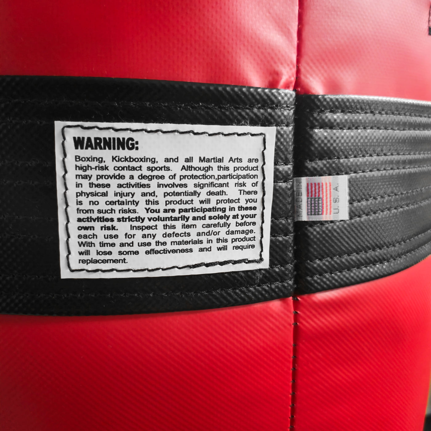 variant:Black/Red::TITLE Boxing Made in the USA 135lb Punching Bag closeup of tags