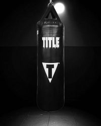 variant:Black/Black::TITLE Boxing Made in the USA 100lb Punching Bag hanging in the gym