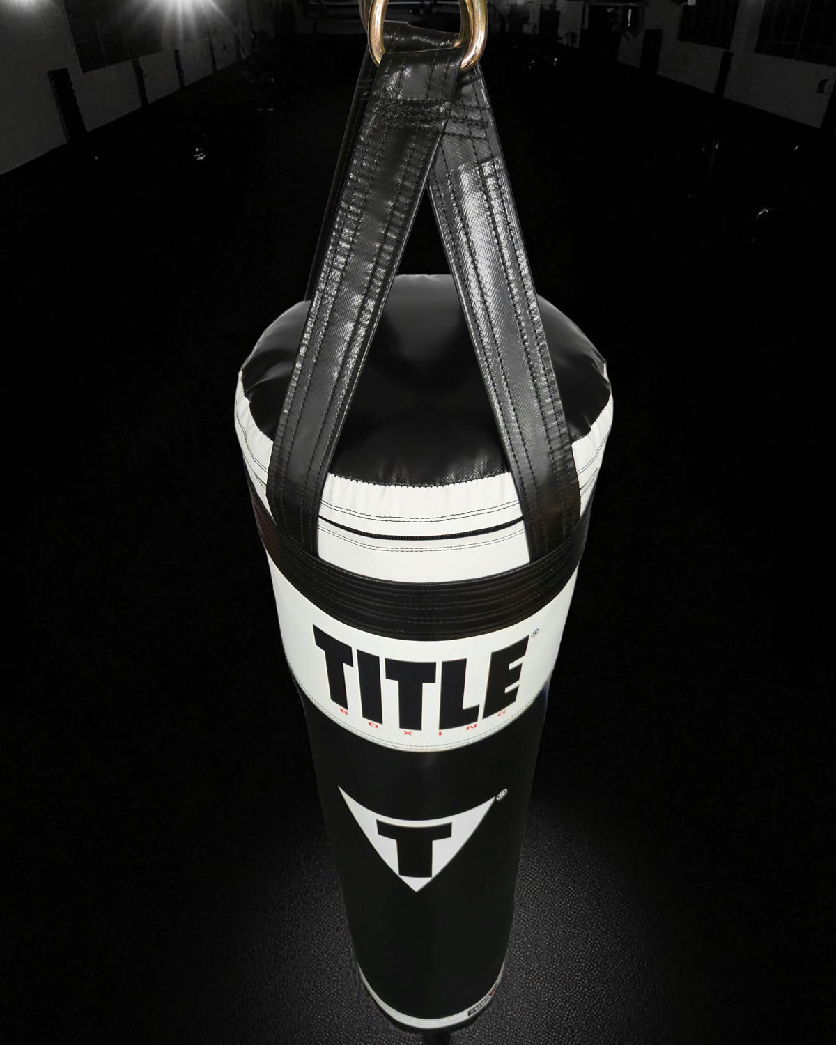 variant:Black/White::TITLE Boxing Made in the USA 135lb Thai Heavy Bag hanging in the gym