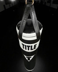 variant:Black/White::TITLE Boxing Made in the USA 135lb Thai Heavy Bag hanging in the gym