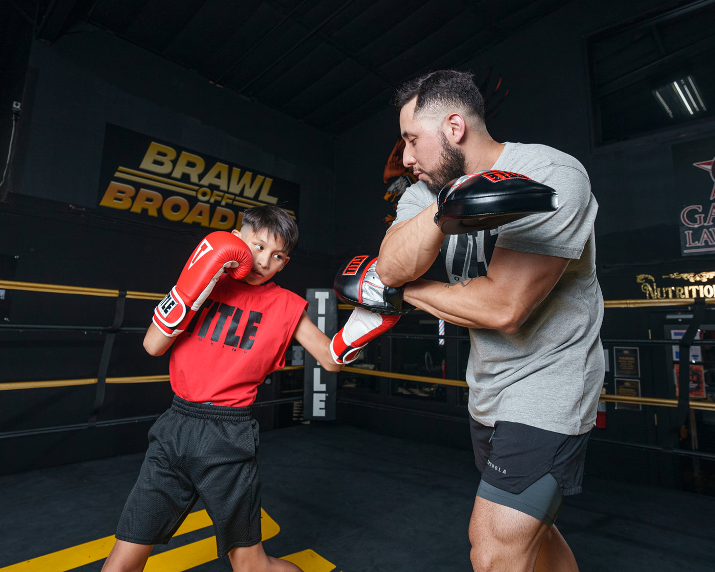 variant:lifestyle::TITLE Boxing Valiant Micro Mitts kid mitting left uppercut