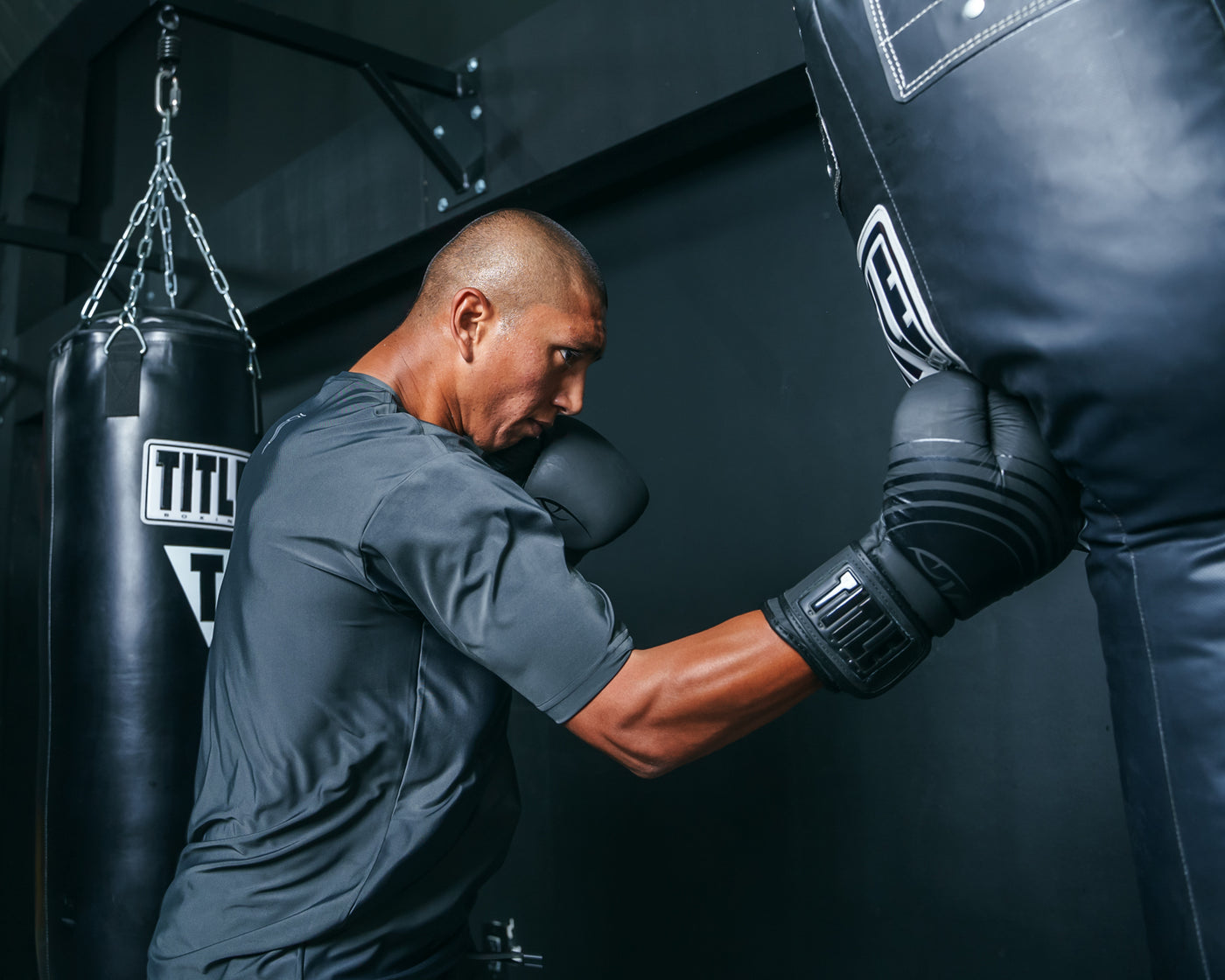 variant:Black::Viper by TITLE Boxing Select Training Gloves 2.0 guy hitting a bag