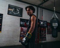 variant:Black/Green::WBC by TITLE Boxing Bag Gloves guy standing looking over shoulder