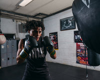 variant:Black/Green::WBC by TITLE Boxing Bag Gloves guy standing looking over shoulder boxing stance
