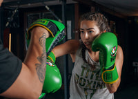variant:Green/Black::WBC by TITLE Boxing Bag Gloves man wearing gloves mitting with coach