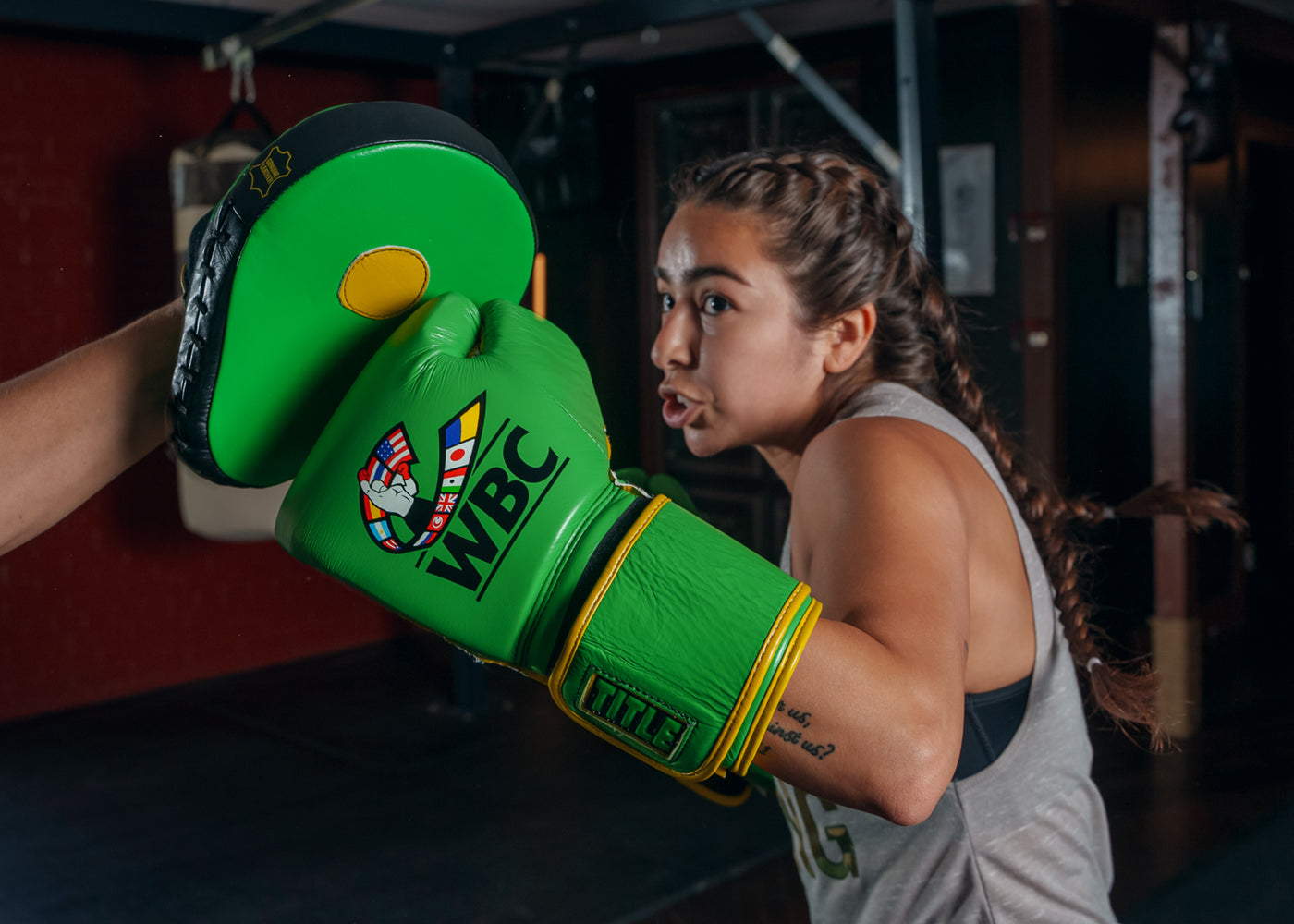 variant:Green/Black::WBC by TITLE Boxing Bag Gloves man wearing gloves mitt left hook coach