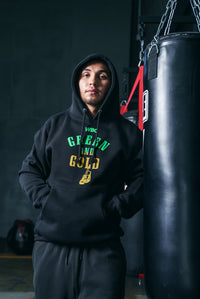 variant:lifestyle::WBC By TITLE Boxing Green & Gold Hoodie guy posing in hoodie