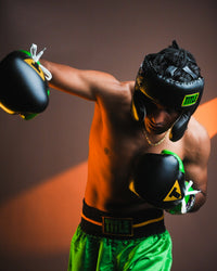 variant:Black::WBC by TITLE Boxing Sparring Headgear on fighter in boxing stance throwing punch