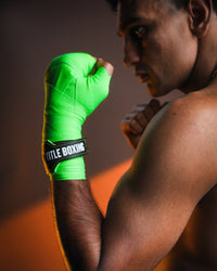 variant:Green/Black::WBC by TITLE Boxing Hand Wraps on boxer's hand closeup