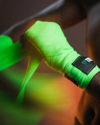 variant:Green/Black::WBC by TITLE Boxing Hand Wraps on boxer's hands being wrapped closeup