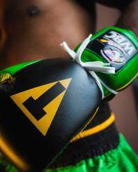 variant:Black/Green::WBC by TITLE Boxing Sparring Gloves on fighter's hand closeup