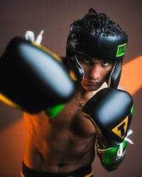 variant:Black/Green::WBC by TITLE Boxing Sparring Gloves on fighter's hand in fighting stance with fists up