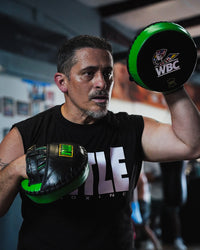 variant:lifestyle::WBC by TITLE Boxing Micro Mitts on coach in gym