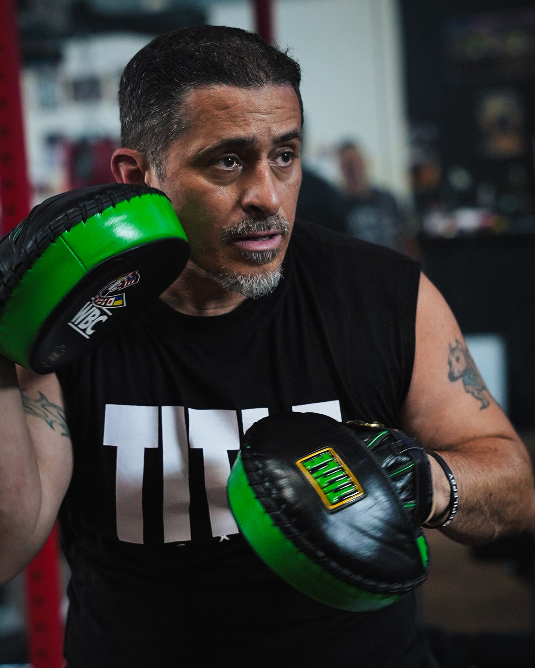 variant:lifestyle::WBC by TITLE Boxing Micro Mitts on coach in gym