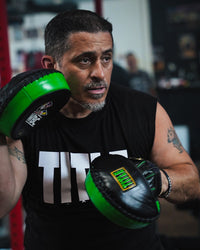 variant:lifestyle::WBC by TITLE Boxing Micro Mitts on coach in gym