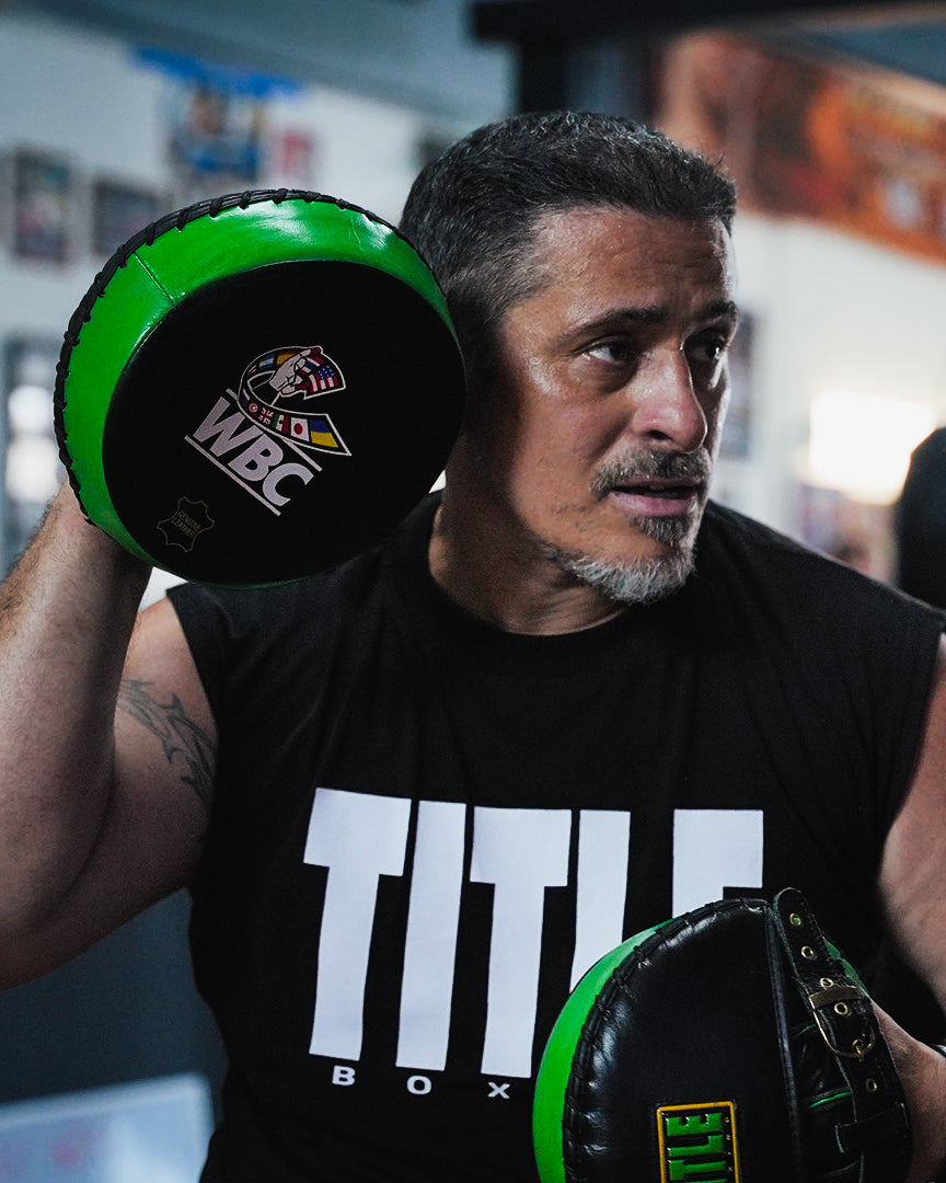 variant:lifestyle::WBC by TITLE Boxing Micro Mitts on coach in gym