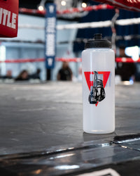variant:lifestyle::TITLE Boxing Pro Plus Water Bottle on the side of a boxing ring