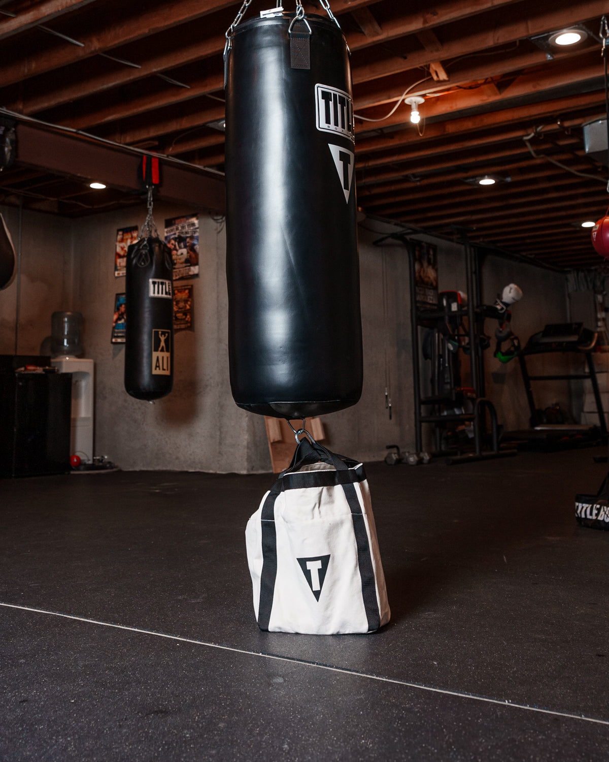 variant:lifestyle::TITLE Boxing Canvas Heavy Bag Anchor in a boxing gym used with a heavy bag