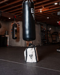 variant:lifestyle::TITLE Boxing Canvas Heavy Bag Anchor in a boxing gym used with a heavy bag