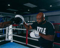 variant:Lifestyle::TITLE White Punch Mitts 2.0 mitts with coach close up