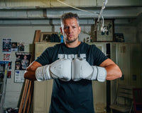 variant:lifestyle::TITLE White Boxing Training Gloves 2.0  guy hands together