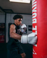 variant:lifestyle::TITLE White Boxing Gloves kid hitting bag