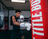 variant:lifestyle::TITLE White Boxing Gloves kid jabbing bag