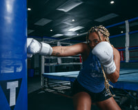 variant:lifestyle::TITLE White Boxing Pro Bag Gloves  girl punching bag left jab