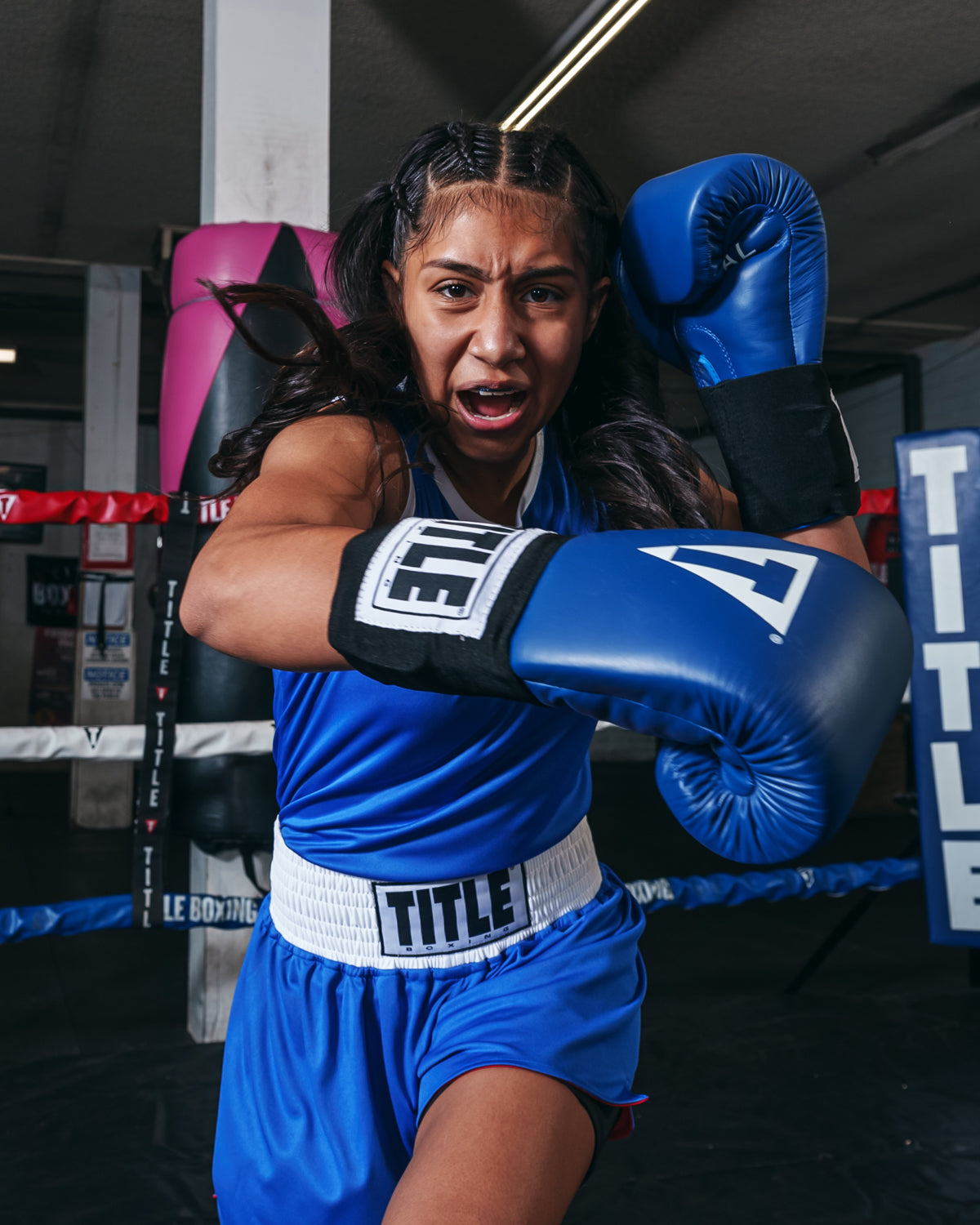 variant:Red/Blue::TITLE boxing Women's Reversible Elite Amateur boxing set blue side on female fighter