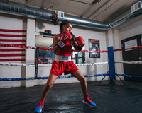 variant:Red/Blue::TITLE boxing Women's Reversible Elite Amateur boxing set on female fighter in the ring