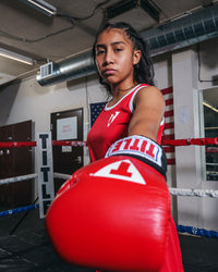 variant:Red/Blue::TITLE boxing Women's Reversible Elite Amateur boxing set red side on female fighter