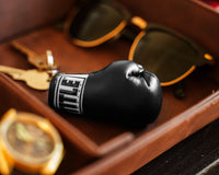 variant:black::TITLE Boxing Excel Glove Keyring  next to glasses