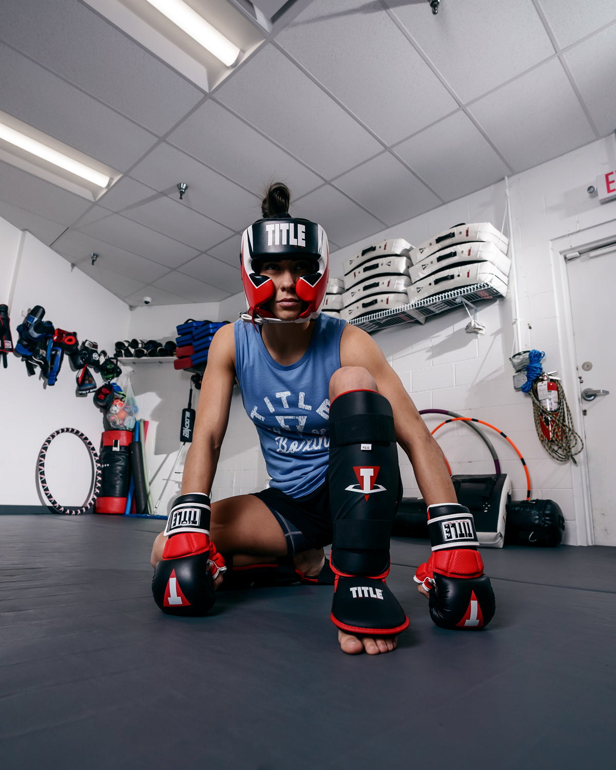 variant:lifestyle::TITLE MMA Command Training Headgear girl sitting on ground