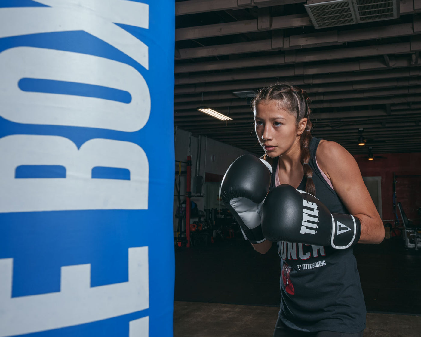 variant:Black/White::TITLE Boxing Dynamic Strike Heavy Bag Gloves girl boxing stance