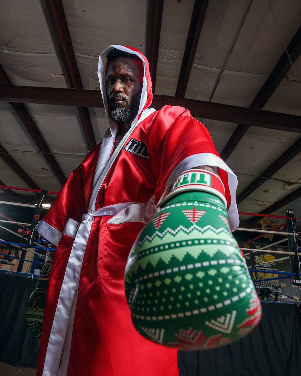 variant:green::TITLE Boxing Limited Edition Deck the halls bag gloves left hand down close up glove