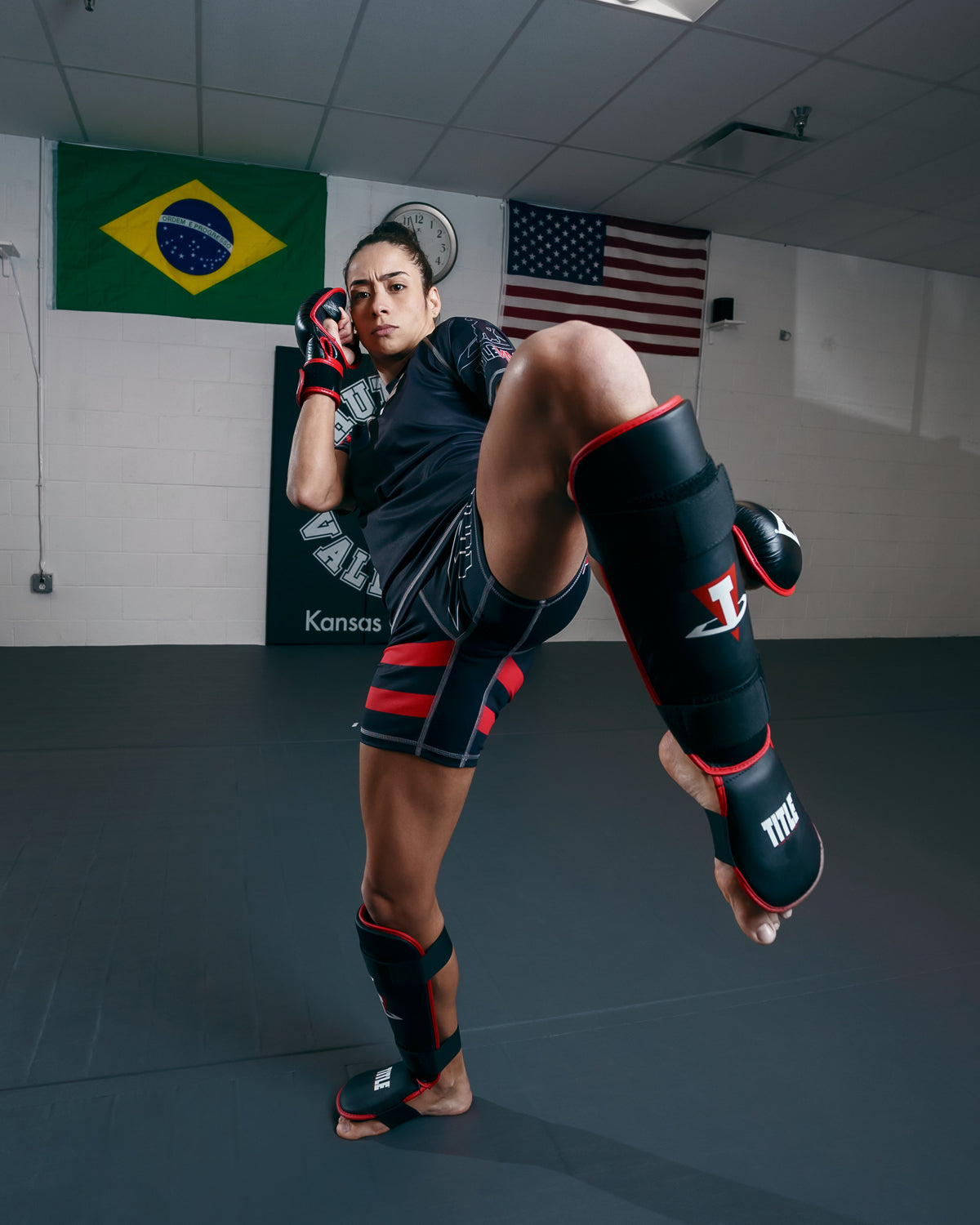 variant:lifestyle::TITLE MMA Conflict Stand Up Shin Guards lady kicking pose