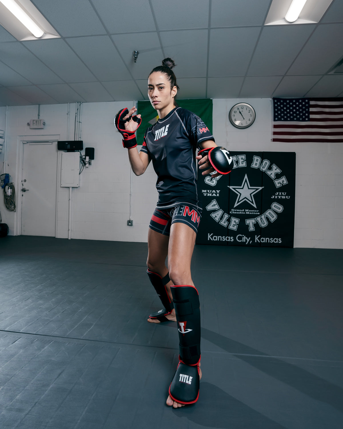 variant:lifestyle::TITLE MMA Conflict Stand Up Shin Guards lady sparing pose