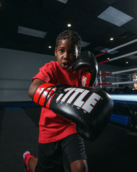 variant:Black/Red/White::TITLE Boxing Pro Style Youth Lace Training Gloves boy throwing right hand