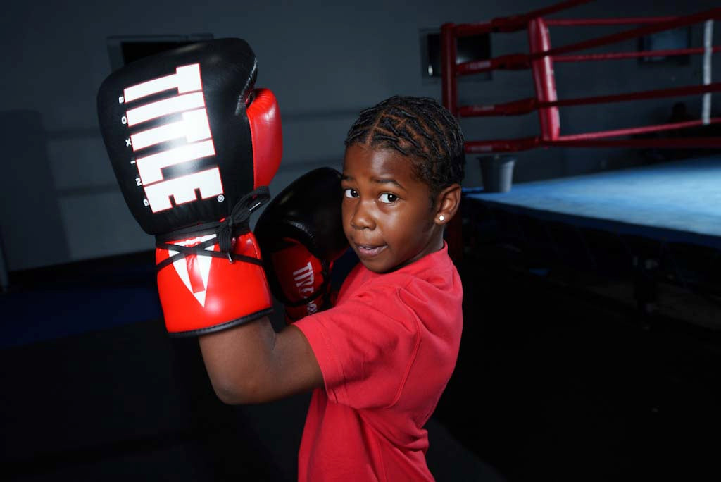 variant:Black/Red/White::TITLE Boxing Pro Style Youth Lace Training Gloves boy throwing left uppercut