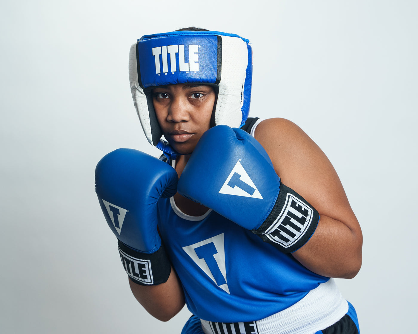 variant:blue::TITLE Boxing Aerovent Elite USA Boxing Competition Headgear – Open Face kid boxing stance
