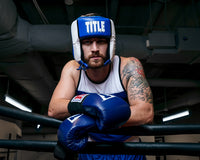 variant:blue::TITLE Boxing Aerovent Elite USA Boxing Competition Headgear – Open Face standing in ring 
