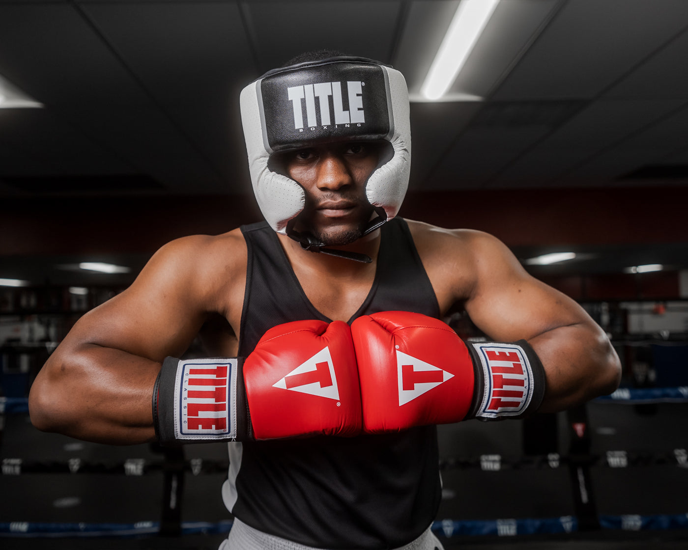 variant:black::TITLE Boxing Aerovent Elite USA Boxing Competition Headgear – With Cheeks man touching gloves